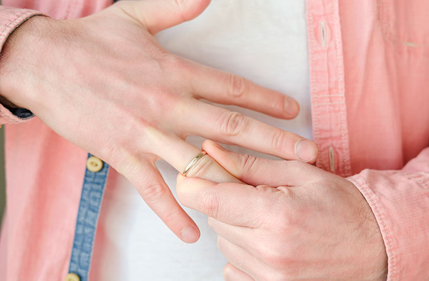 結婚指輪を外そうとする既婚男性